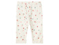 Witte babybroek met roze en groene stippen.