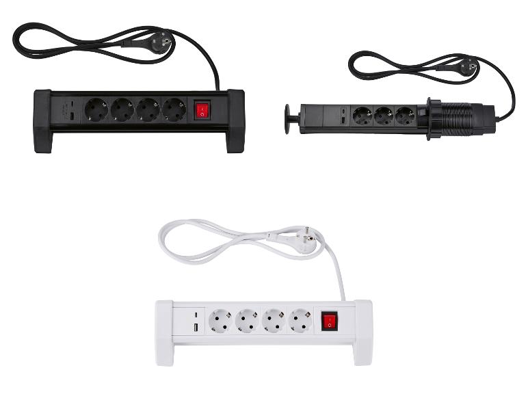 Drie stekkerdozen: twee zwarte (één standaard, één pop-up) en één witte, allemaal met USB-poorten.