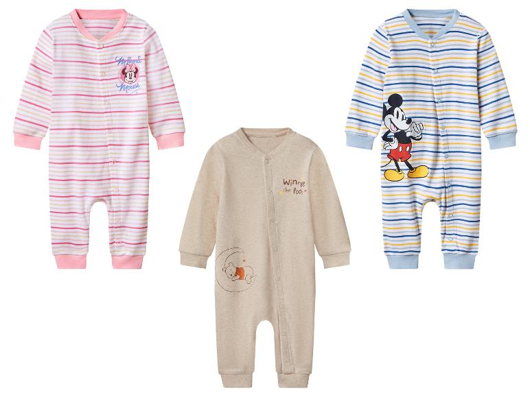 Drie babyrompertjes: een roze gestreepte met Minnie Mouse, een beige met Winnie de Poeh, een blauw gestreepte met Mickey Mouse.