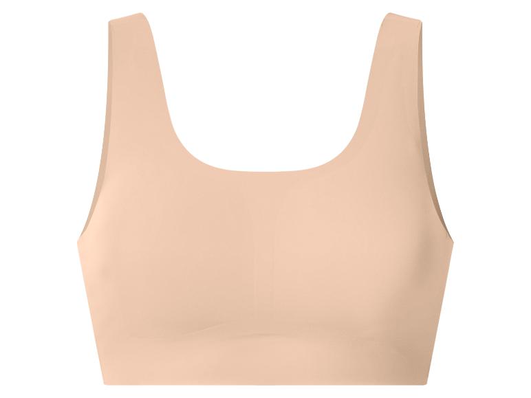 Naadloze beige sportbeha voor dames.