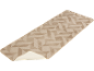 Beige loper met geometrisch patroon, deels opgerold om de achterkant te tonen.
