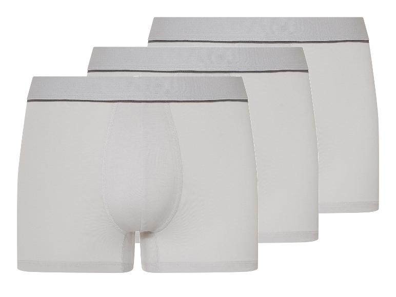 Drie witte boxershorts met een grijze elastische tailleband.