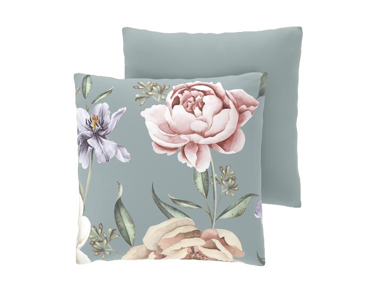 Twee kussens, één met bloemen- en bladpatroon, de andere effen grijsgroen.