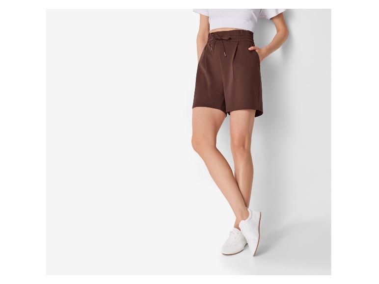 Bruine shorts en witte sneakers voor dames.