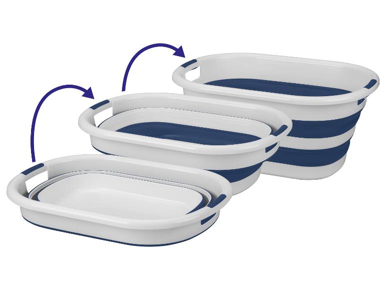 Drie opvouwbare wasmanden in wit en donkerblauw.