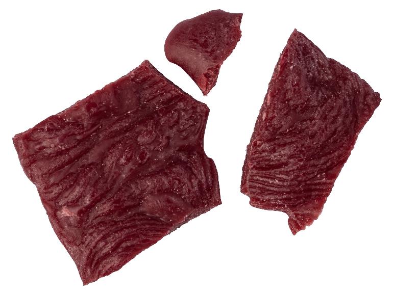 Stukjes gedroogd vlees op een witte achtergrond.