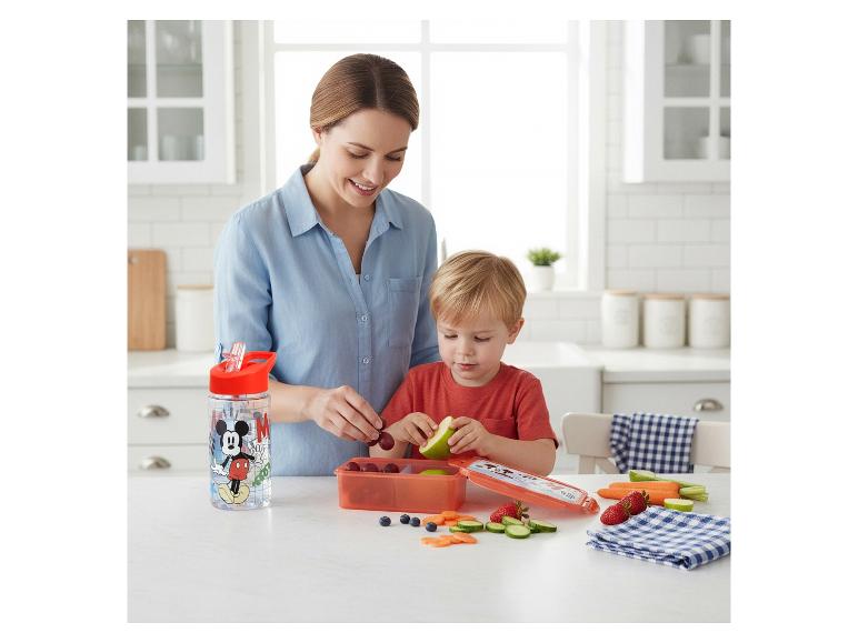 Moeder en kind bereiden een gezonde snack met een waterfles en lunchbox.
