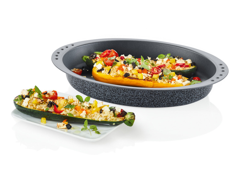 Gevulde courgettes met rijst, feta en groenten in een bakvorm.