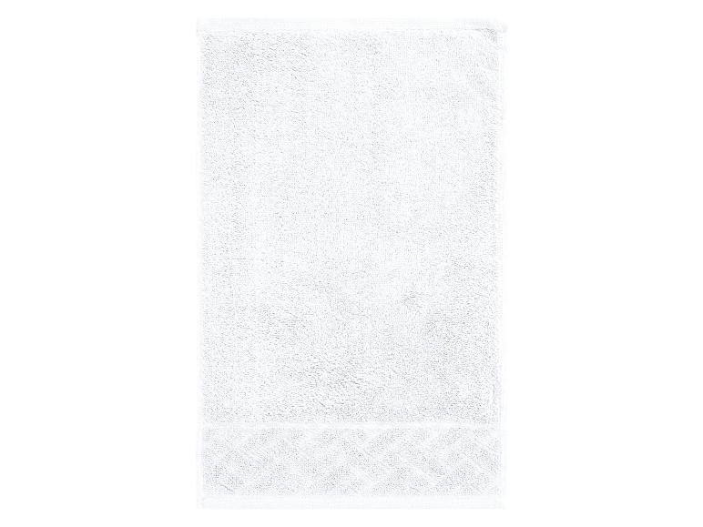 Een witte handdoek met een gedetailleerd patroon.