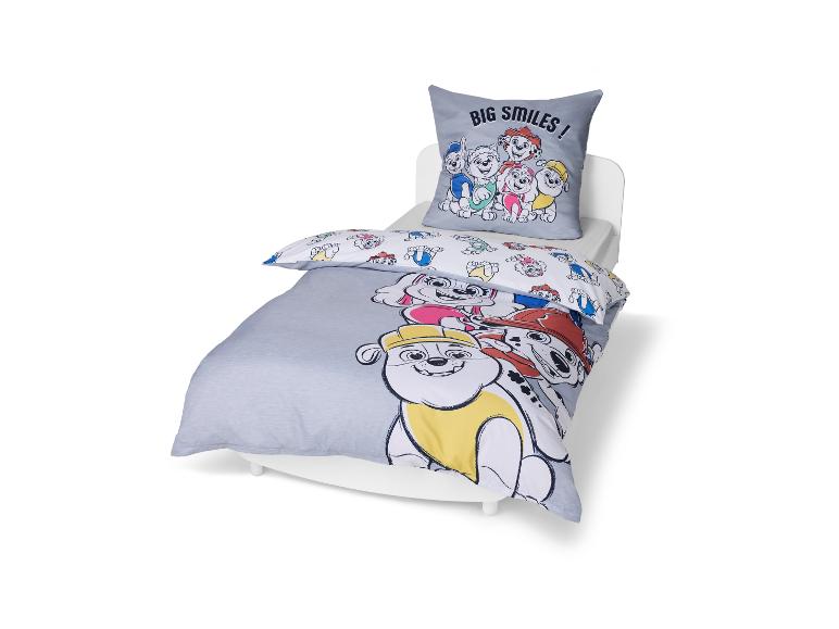 Kinderbeddengoedset met kussen en dekbed, met cartoonhondenprints en de tekst 'BIG SMILES!'.