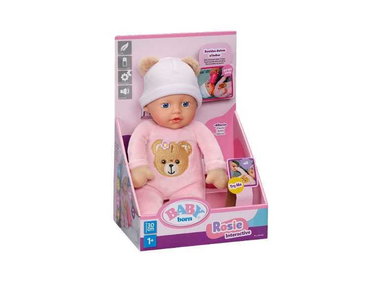 Interactieve babypop in roze kruippakje en muts in de verpakking.