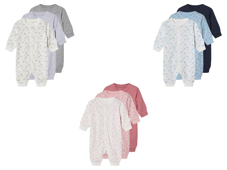 Drie baby slaappakjes, wolkjes en dierenprint, pastelkleuren.