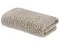 Gevouwen beige handdoek met geribbelde textuur