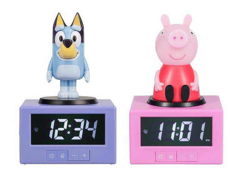 Twee wekkers met figuren, een blauwe hond en een roze varken, die verschillende tijden tonen.