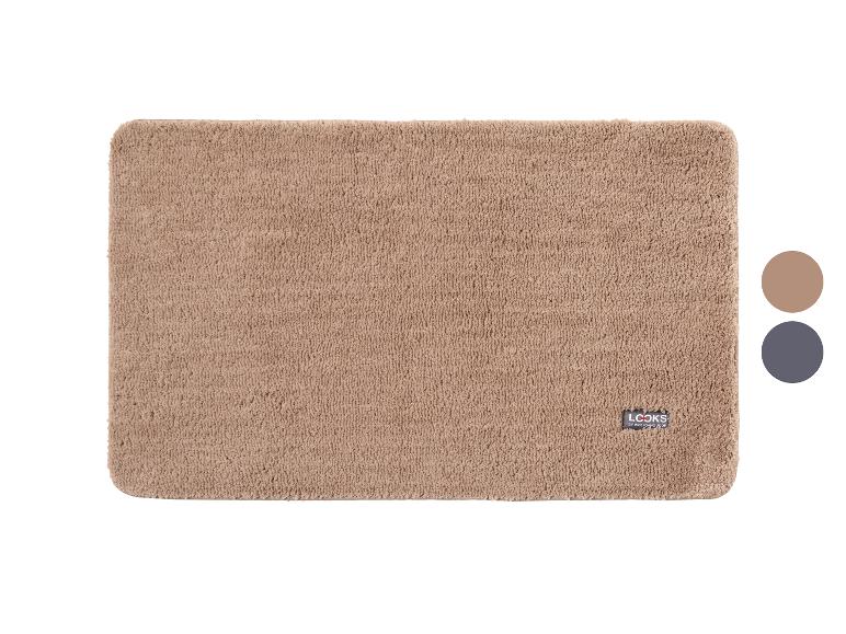 Beige badmat met logo en twee kleurmonsters aan de rechterkant.