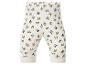 Witte babybroek met cartoonfigurenprint en kleurrijke stippen.