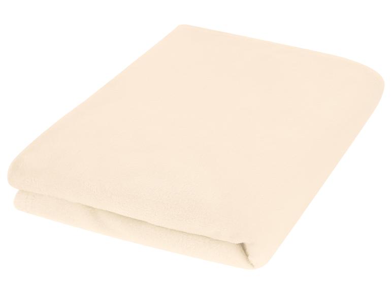 Opgevouwen crèmekleurige fleecedeken