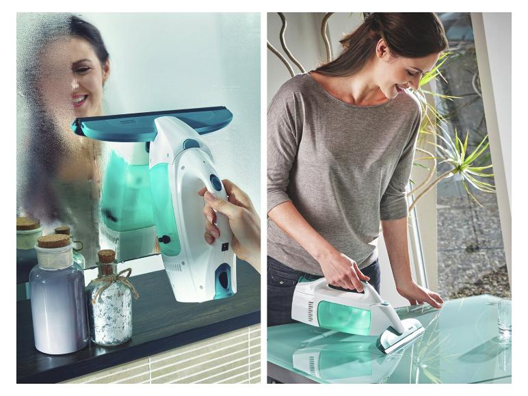 Vrouw gebruikt een handstofzuiger om een spiegel en glazen tafel schoon te maken.