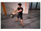 Man in zwarte sportkleding traint met een zwarte kettlebell.
