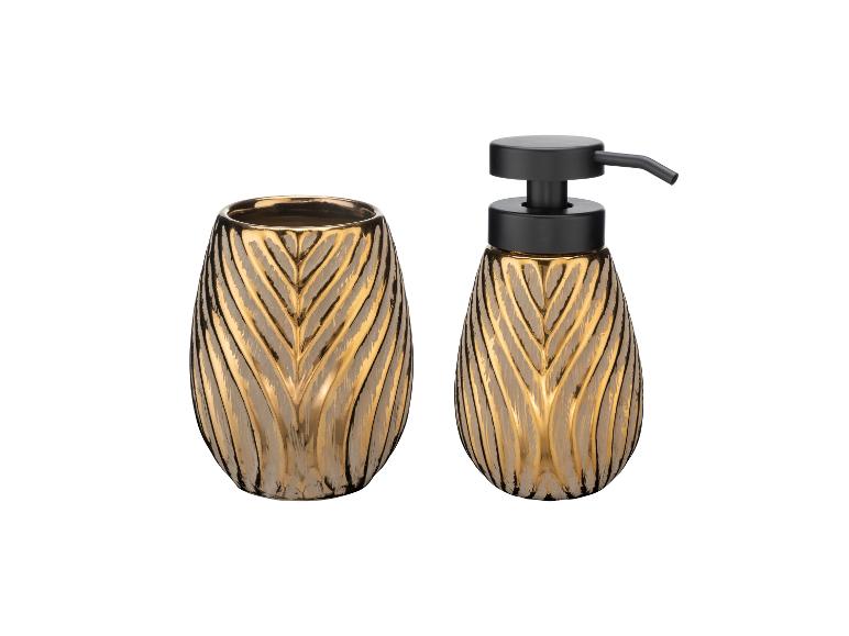 Moderne gouden zeepdispenser en tandenborstelhouder set.