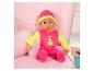 Babypop in roze en gele outfit met fles en speen, zittend op een stoel met sterrenpatroon.