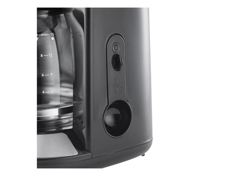 Zwart koffiezetapparaat met glazen kan en waterniveau-indicator.