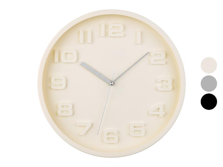 Ronde wandklok, minimalistisch design, crèmekleurig.