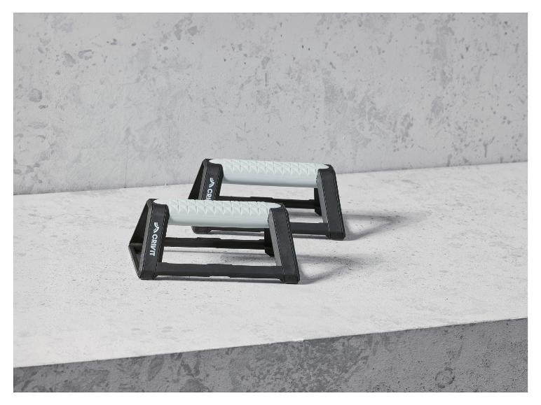 Twee zwarte Crivit push-up bars op een betonnen oppervlak.