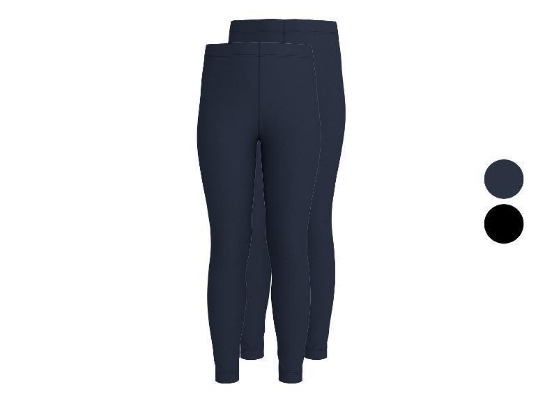 Twee paar donkerblauwe kinderleggings, één paar zwarte leggings.