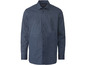 Een donkerblauw overhemd met witte stippen.