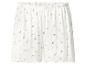 Witte geribbelde shorts met een delicaat roze bloemenpatroon en een rucheszoom.