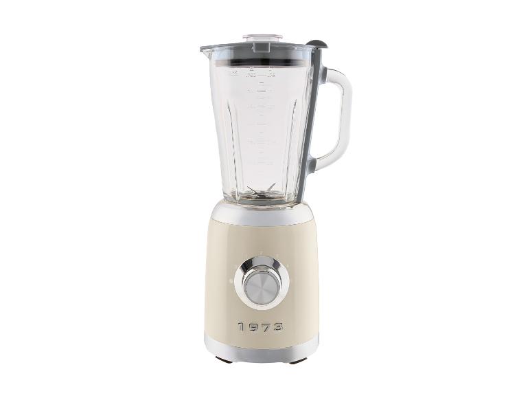Crèmekleurige retro blender met glazen kan en chromen bedieningsknop.