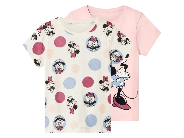 Twee kinder T-shirts met korte mouwen: één wit met Minnie Mouse-patroon en stippen, en één roze met een grote Minnie Mouse-print.