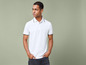 Man met een wit poloshirt en zwarte jeans.