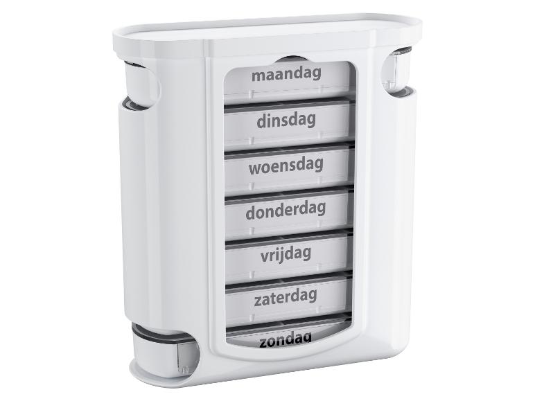 Witte wekelijkse pillendoos met compartimenten voor elke dag van de week.