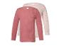 Twee geribbelde longsleeves voor kinderen, één roze en één lichtroze met stippen.