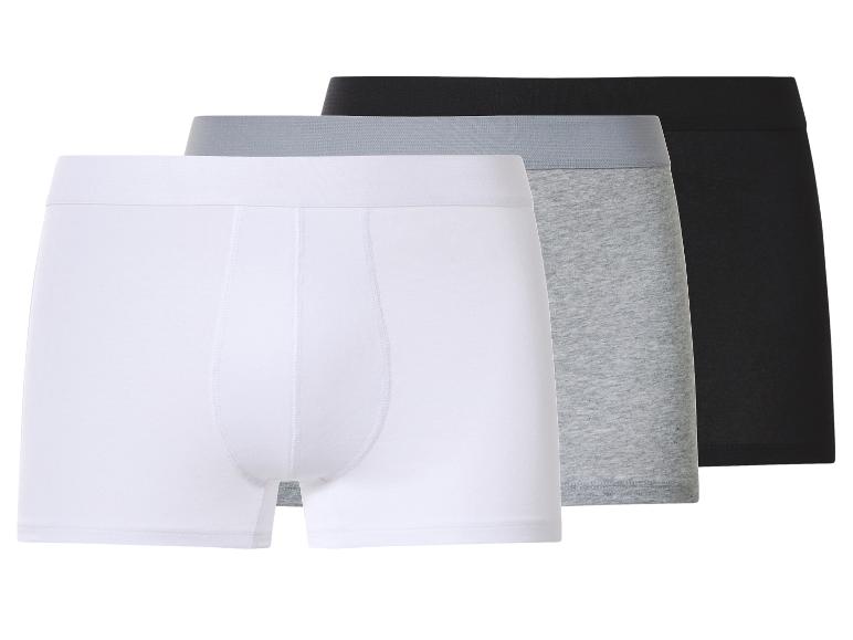 Drie herenboxershorts in wit, grijs en zwart.
