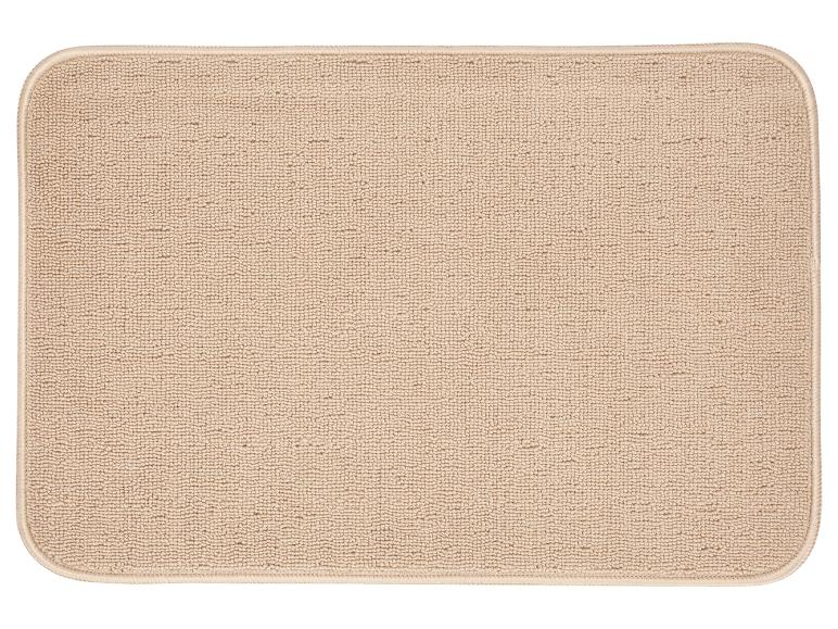 Beige rechthoekige deurmat met afgeronde hoeken.