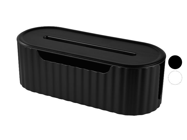 Zwarte ovale kabelmanagementbox met geribbelde textuur en een gleuf bovenaan.