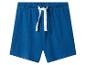 Blauwe katoenen kinderbroek met wit trekkoord in elastische tailleband.