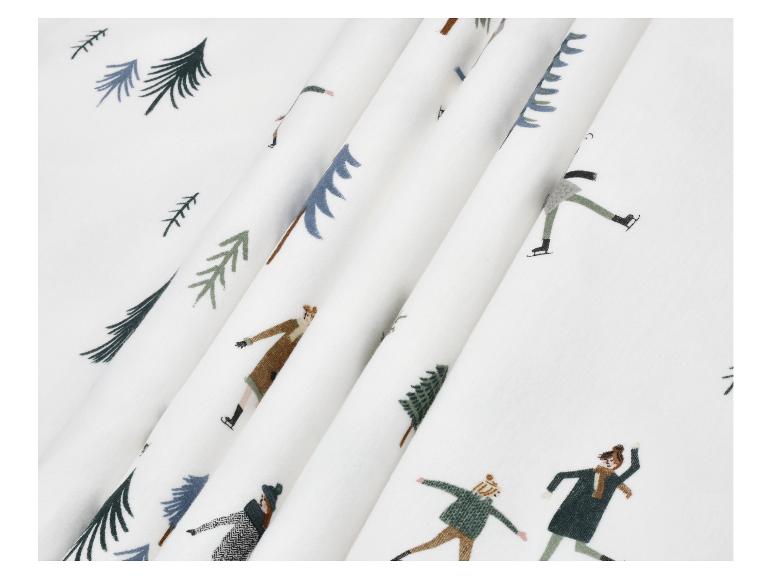 Witte stof met print van dennenbomen en schaatsende mensen