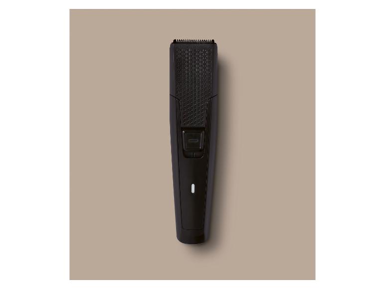 Zwarte baardtrimmer met geometrisch patroon en aan/uit-knop.