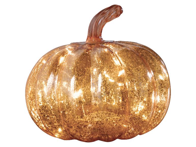 Een decoratieve glazen pompoen met een warme, verlichte gloed, perfect voor herfstdecoratie.