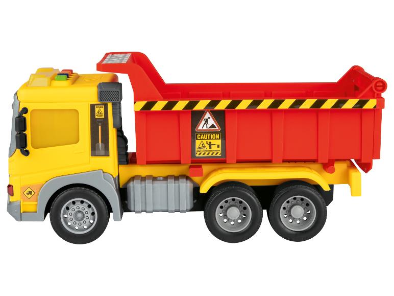 Gele en rode speelgoedkiepwagen met waarschuwingsborden