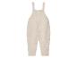 Beige gebreide baby overall.
