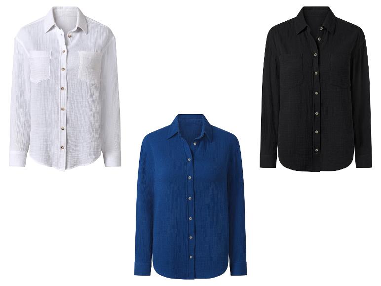 Drie overhemden in verschillende kleuren: wit, zwart en blauw.