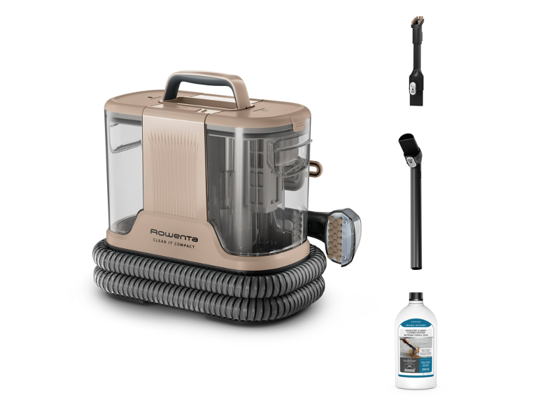Compacte tapijtreiniger met accessoires en reinigingsoplossing.
