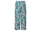Lange, groene broek met een tropische print.