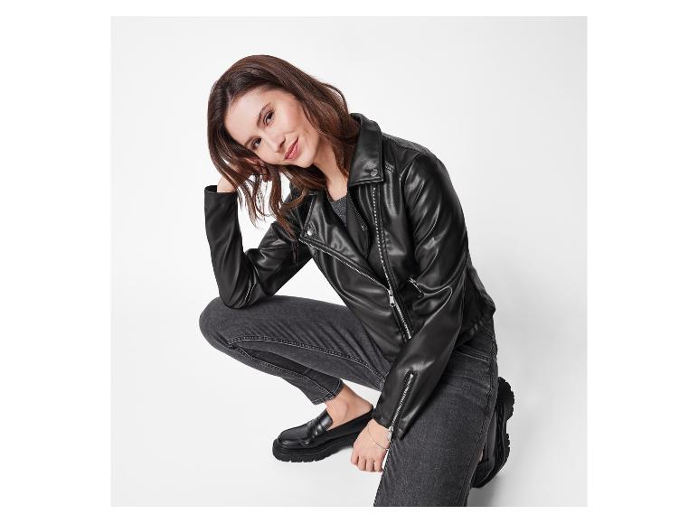 Vrouw in zwart leren jack en jeans.