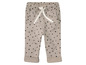 Beige broek met zwarte stippen.